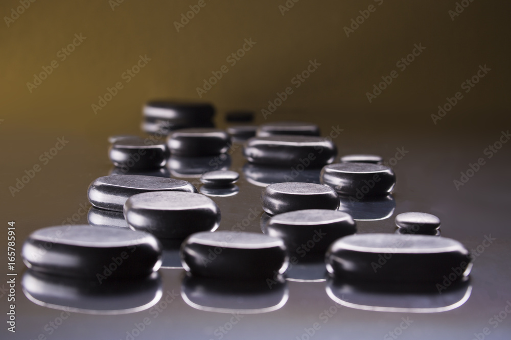 Black pebbles on a gold background Black pebbles on a gold background