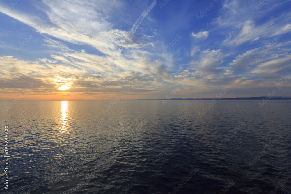 Fototapeta premium Sky and sea in the sunset, Beautiful colorful sunset with reflection, Dramatic sky background