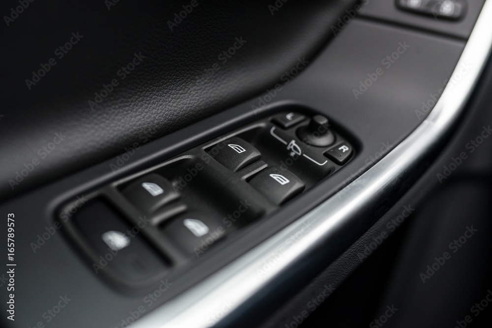 Close-up on power windows and mirrors control buttons