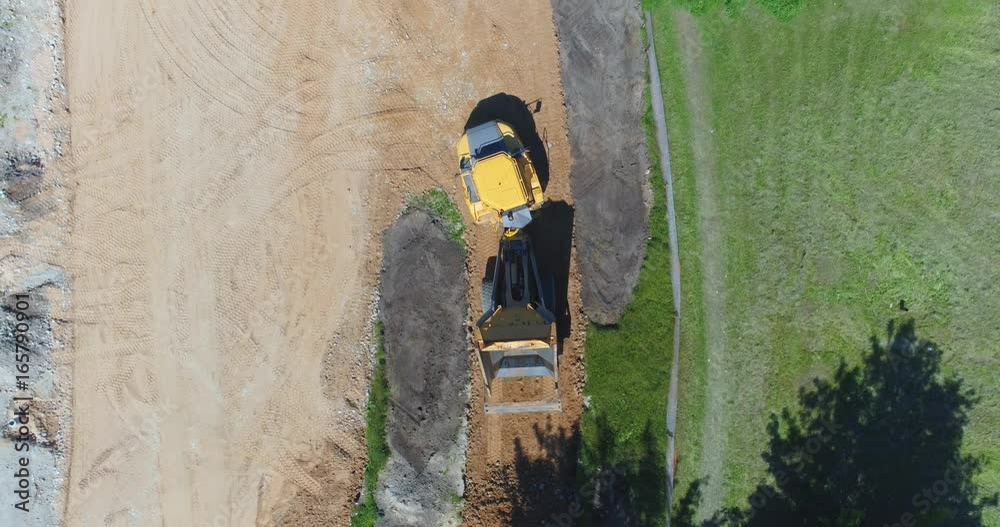 Aerial view of truck full of soil moving on construction site. The truck pours out the rock. Aerial footage. Aerial view of truck full of soil moving on construction site. The truck pours out the rock. Aerial footage.