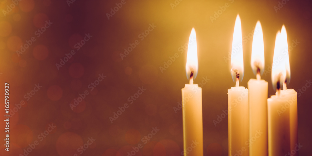 Group of still life golden candle light with reflection on soft red blurred background. Abstract background for pray or meditation caption and hope concept Group of still life golden candle light with reflection on soft red blurred background. Abstract background for pray or meditation caption and hope concept