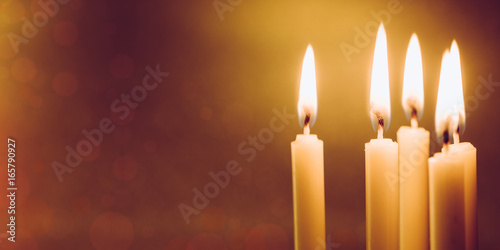 Group of still life  golden candle light with reflection on soft red blurred  background. Abstract background for pray or meditation caption and hope concept