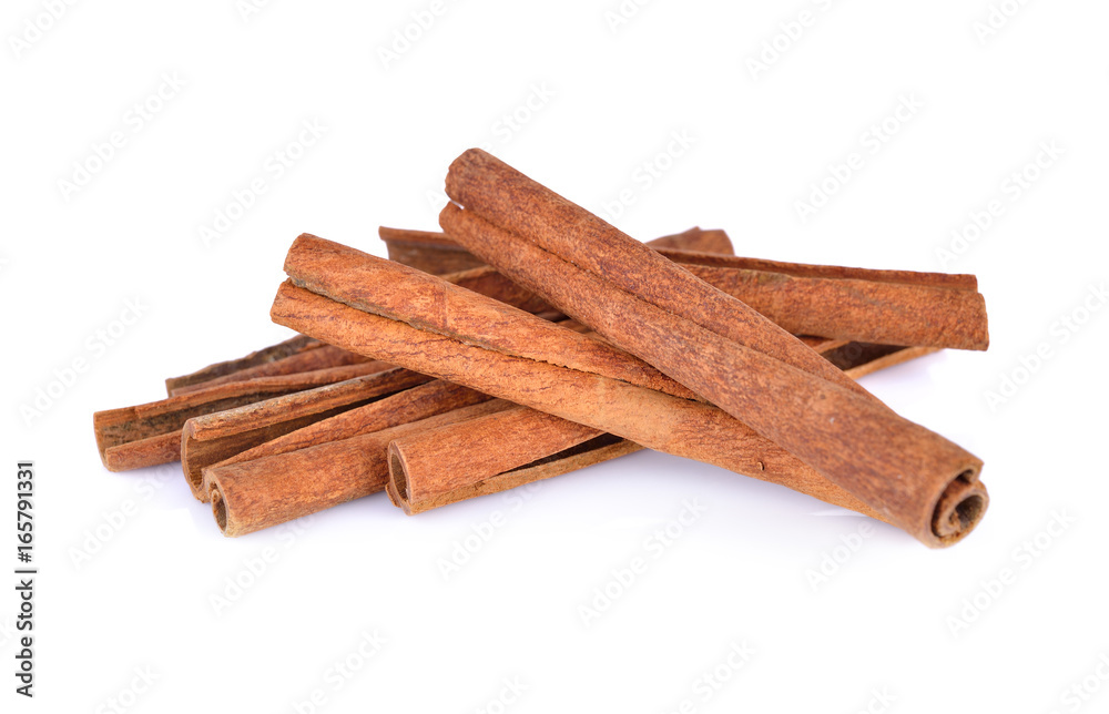 pile of dried cinnamon on white background