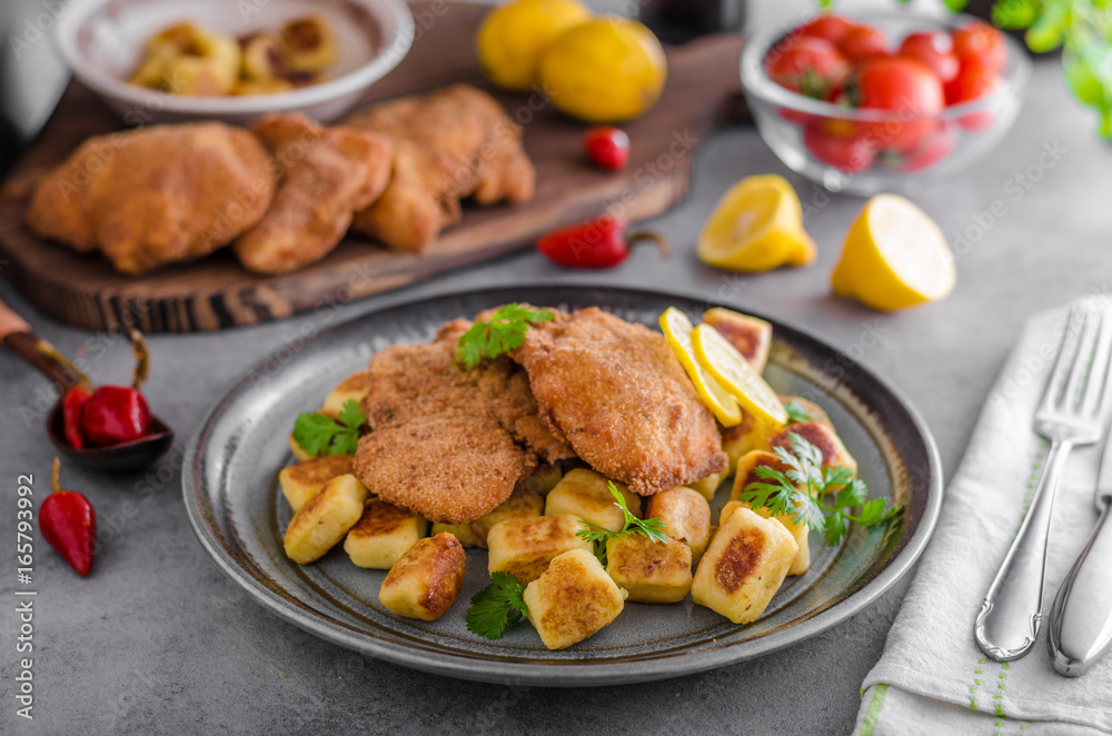 Schnitzel original with lemon and gnocchi fried Schnitzel original with lemon and gnocchi fried