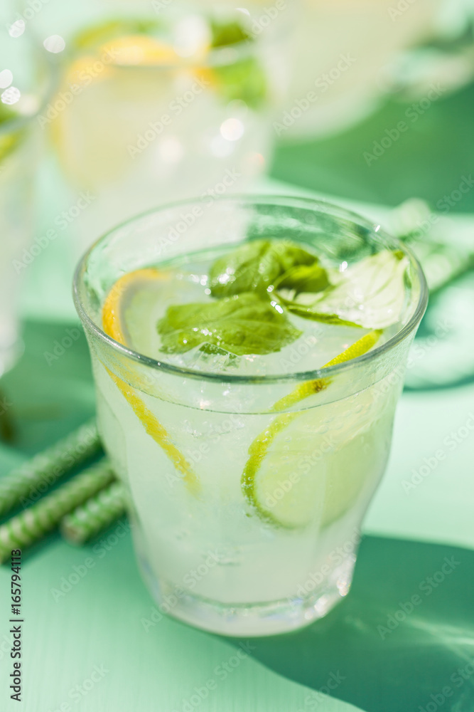 refreshing lemonade drink with mint lime lemon in garden refreshing lemonade drink with mint lime lemon in garden
