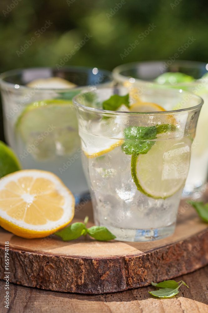 refreshing lemonade drink with mint lime lemon in garden refreshing lemonade drink with mint lime lemon in garden