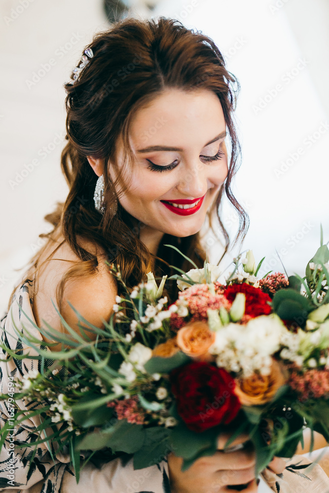 Smiling bride with red lips and beautiful bouquet in the morning Smiling bride with red lips and beautiful bouquet in the morning