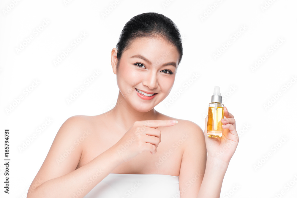 Health, spa and beauty concept. Asian woman with perfect skin holding oil bottle