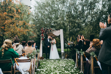 Beautiful wedding couple on the wedding autumn ceremony