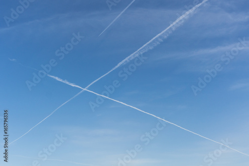 Contrail in the blue sky in the form of X. Heavenly intersection.