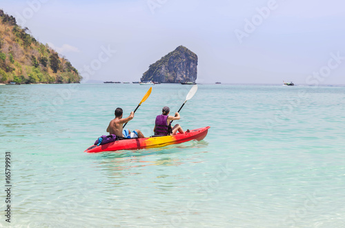 Couple paddling kayak in the andaman sea 
