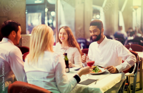 middle class people enjoying food in cafe terrace