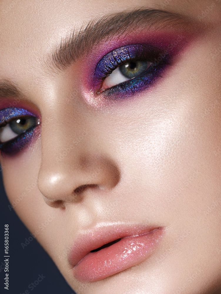 Obraz premium Beautiful young model with fashion make up, perfect skin. Trendy colorful smoky eyes. Lilac smoky eyes