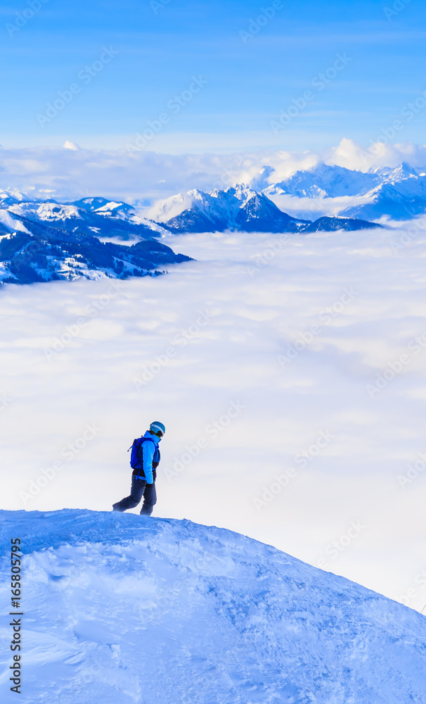 Tourist on top of the mountain of the ski resort Soll, Tyrol, Austria