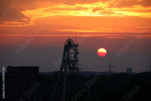 Förderturm der Zeche Ewald im Ruhrgebiet bei Sonnenuntergang photo