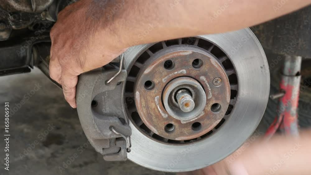 People hand working maintenance fixing and repair front disc brake car. People hand working maintenance fixing and repair front disc brake car.