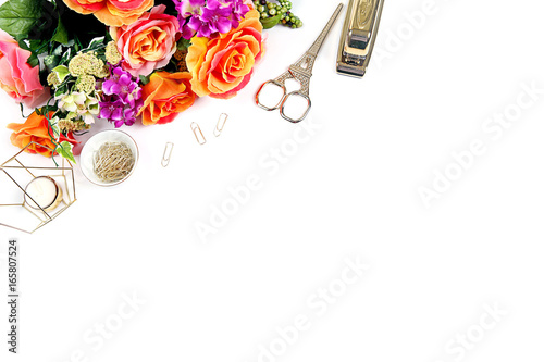 Styled desktop with whte bckground, flowers, gold stapler, gold accessories photo