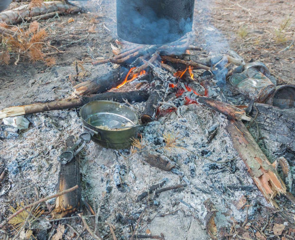 Breakfast in nature, cereal in a bowl, heated on a fire. Breakfast in nature, cereal in a bowl, heated on a fire.