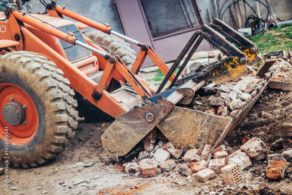Fototapeta premium Industrial backhoe crusher loading demolition debris