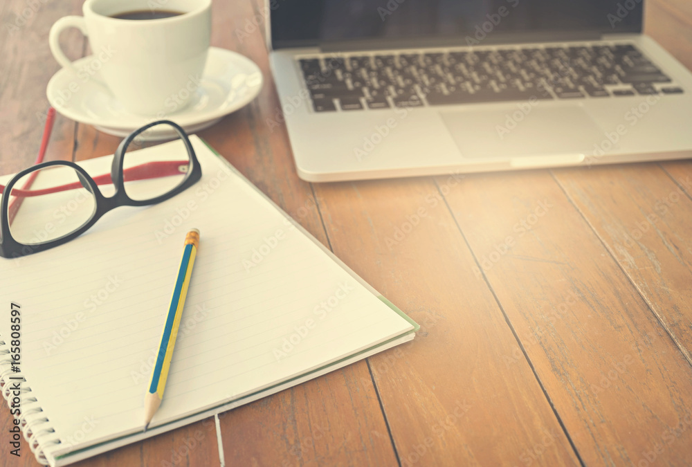 Wooden table with notepad, computer and coffee cup. View from above with copy space. Wooden table with notepad, computer and coffee cup. View from above with copy space.