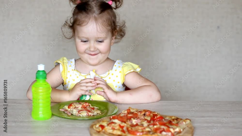 The child eats pizza and drinks lemonade. Cafe and fast food. The child eats pizza and drinks lemonade. Cafe and fast food.