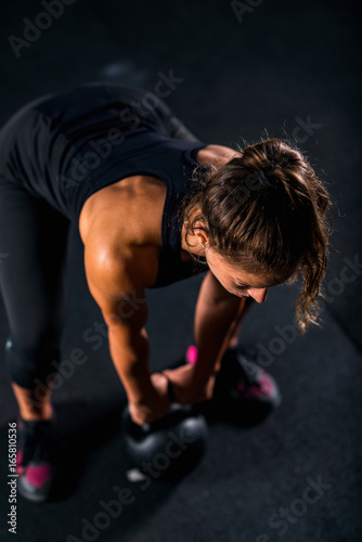 Woman athlete exercising with kettlebell