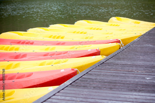 Group of red, yellow color Kayak stop at the port photo