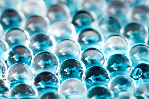 Blue shiny water gel balls. Macro photo  can be used both for advertising or cosmetics and for medicine. Abstract background.