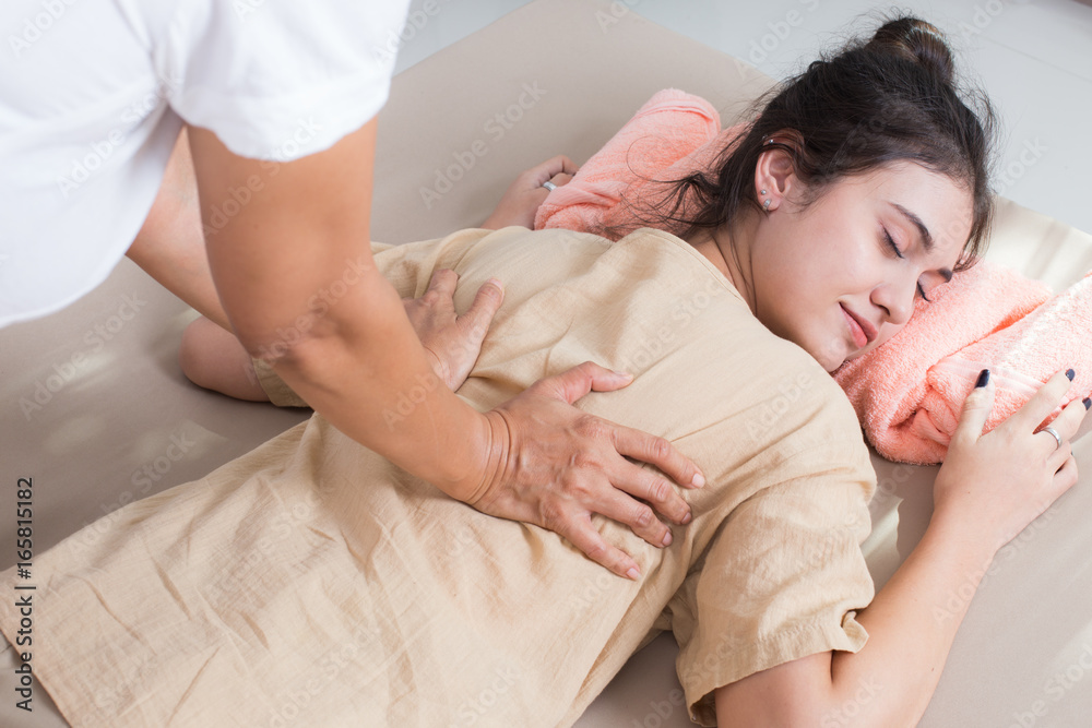 Beautiful young woman having body massage in spa salon. Woman with thai massage. Woman with relax emotion. Beautiful young woman having body massage in spa salon. Woman with thai massage. Woman with relax emotion.