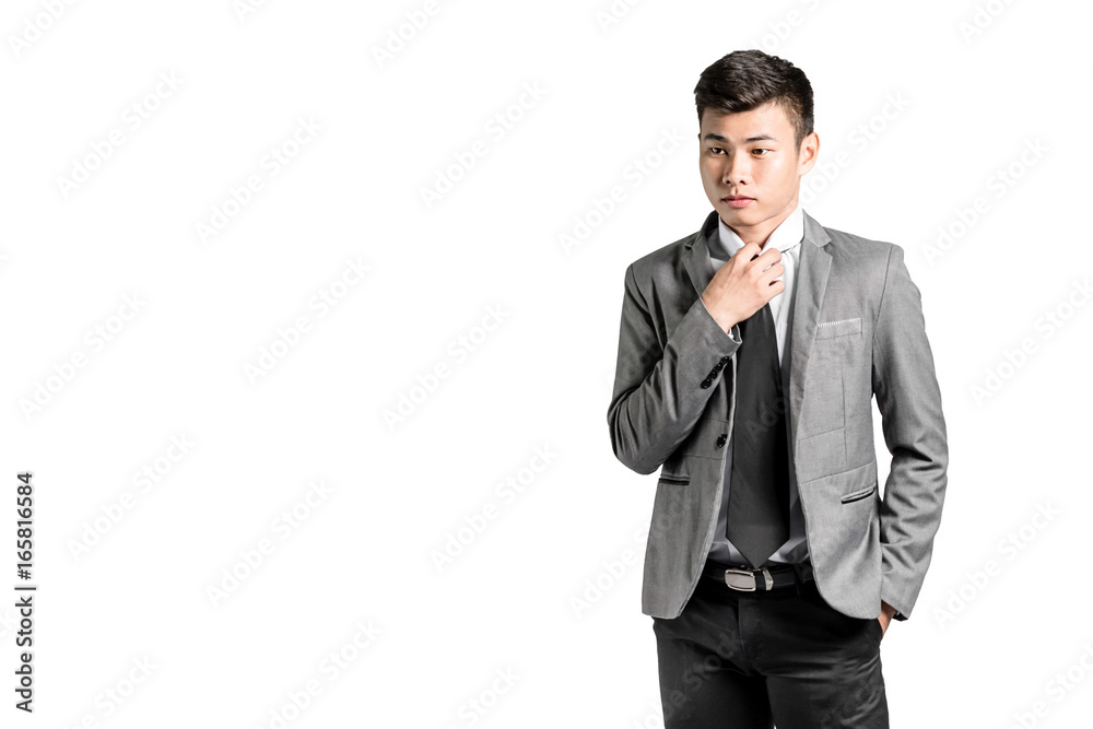 Portrait of a young asian businessman adjusting his tie. Isolated on white background with copy space and clipping path Portrait of a young asian businessman adjusting his tie. Isolated on white background with copy space and clipping path