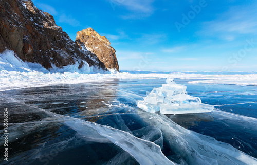 Baikal Lake in winter. Olkhon Island. Ice pyramid of tourists near the natural landmark Deva Rock (Virgin Rock) at the northern Cape Khoboy