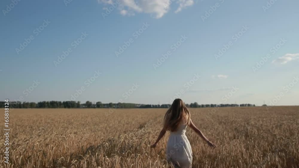 Woman in white dress running through wheat field Woman in white dress running through wheat field