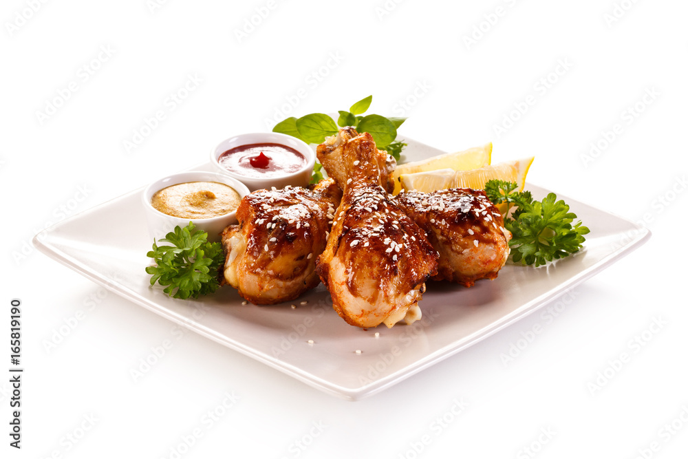 Roast chicken drumsticks on white background Roast chicken drumsticks on white background
