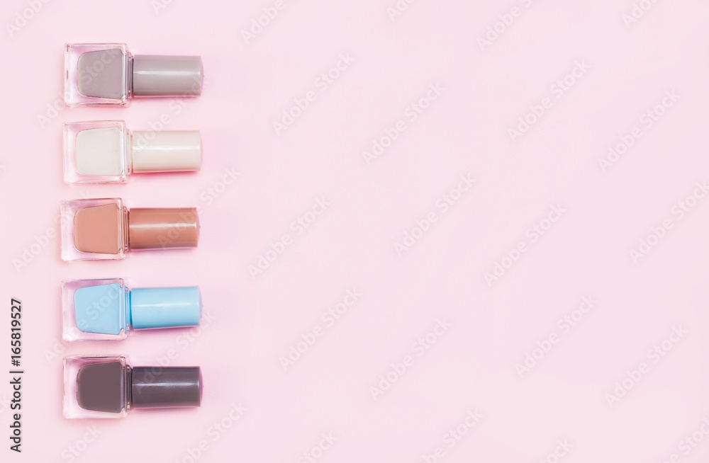 Creative flat lay of fashion bright nail polishes on a colorful background. Minimal style. Copy space. Beauty blogger concept. Top view. Creative flat lay of fashion bright nail polishes on a colorful background. Minimal style. Copy space. Beauty blogger concept. Top view.