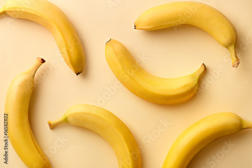 Banana pattern on a yellow background. Exotic fruit repetition viewed from above. Top view.