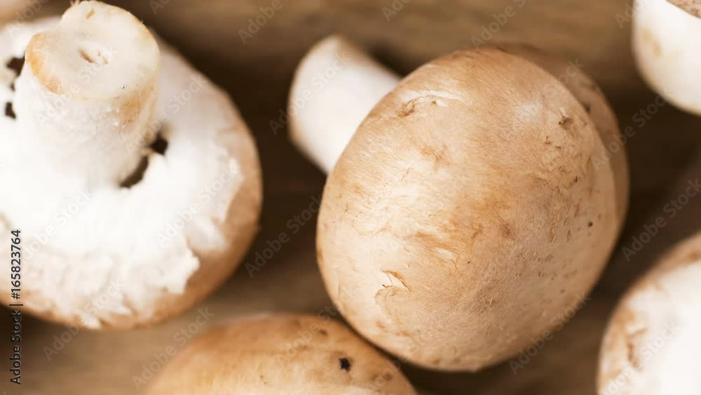 Slowly panning across fresh mushrooms on a wooden chopping board Slowly panning across fresh mushrooms on a wooden chopping board