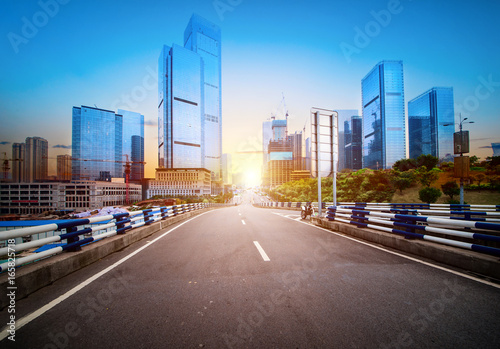 road and buildings at city with sunset