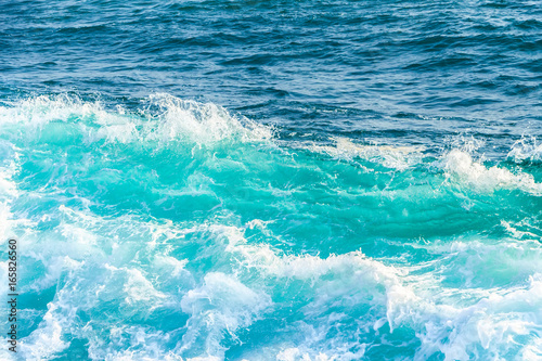 Beautiful blue wave in tropical ocean. Turquoise wave barrel crashing in sea. Close up. © Лев Малевич