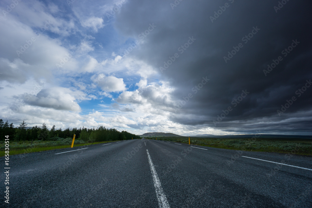 Iceland - Empty highway under dark thunderstorm clouds