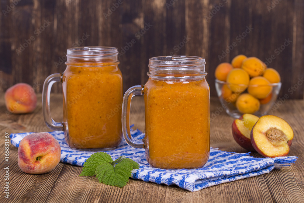 Healthy eating, food, dieting and vegetarian concept - smoothie from apricot and peach in mug, close up. Healthy eating, food, dieting and vegetarian concept - smoothie from apricot and peach in mug, close up.