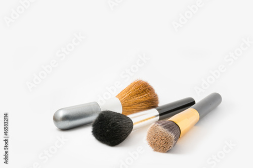 Beautiful photo of three cosmetic brushes isolated on white background
