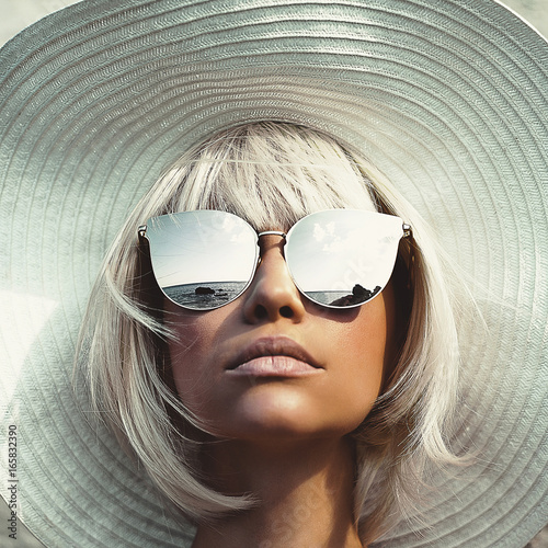 Beautiful lady in hat and sunglasses photo