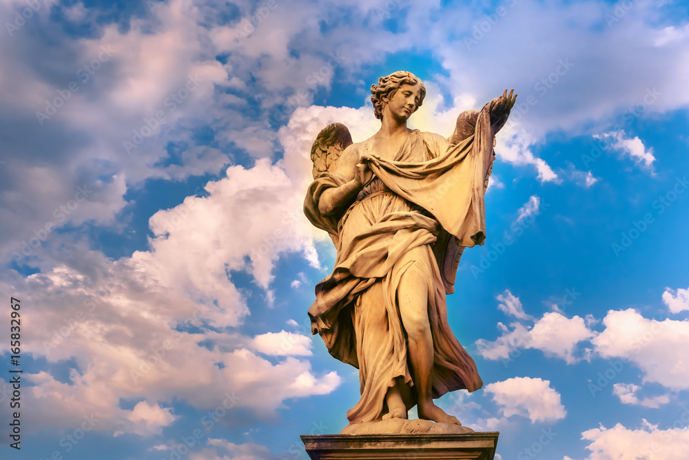Marble statue of Angel with the Sudarium at sunset, one of the ten angels on Saint Angel Bridge, symbols of Christ's Passion, Rome, Italy