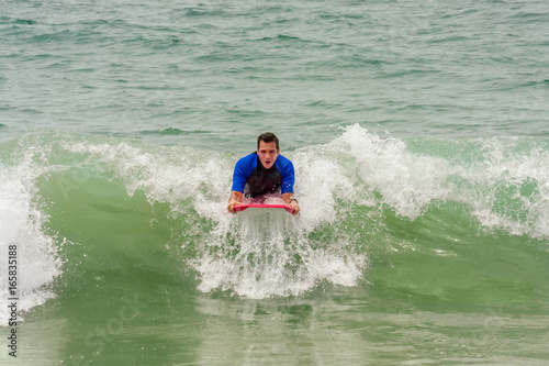 Man Riding a Wave on a Boogie Board © jbrown
