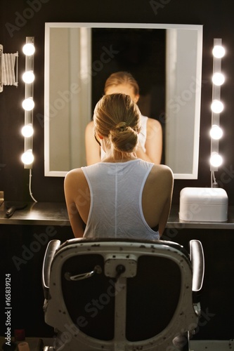 Professional actress in front of backstage mirror