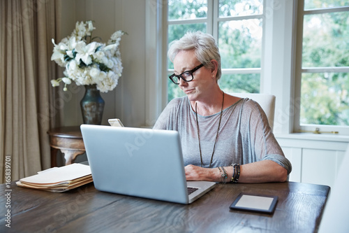 Stylish mature woman working from home photo