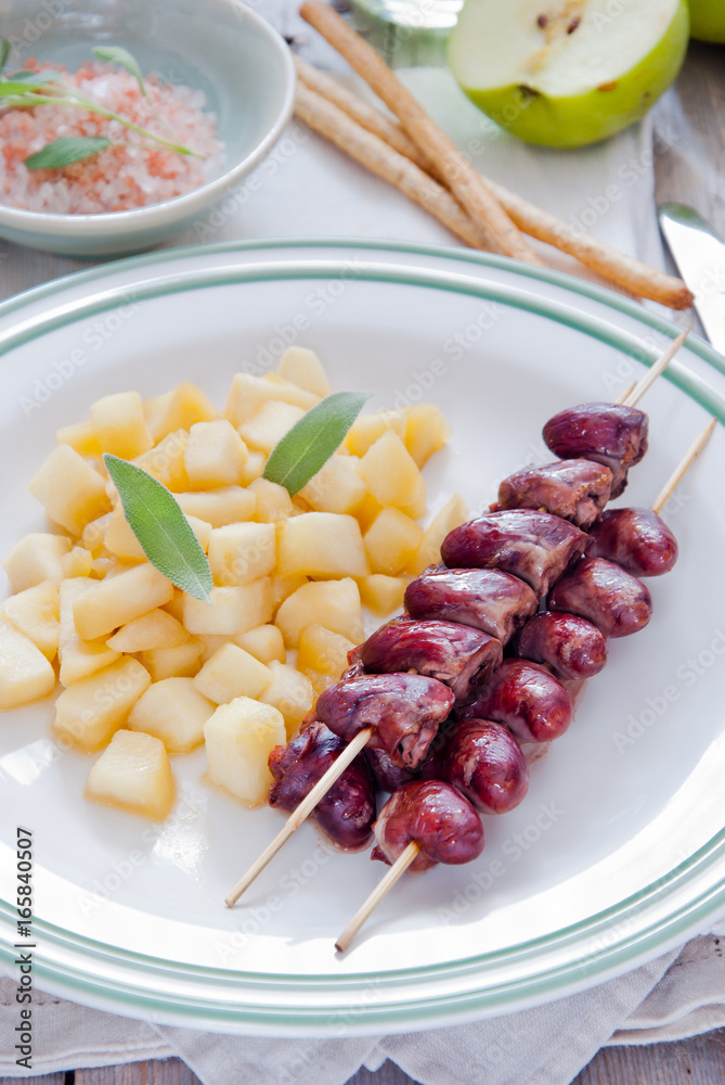 Grilled chicken hearts on skewers with stewed apples Grilled chicken hearts on skewers with stewed apples