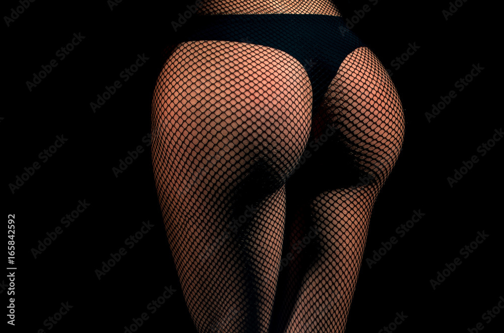 Ass and hips wearing black fishnet pantyhose tights and panties