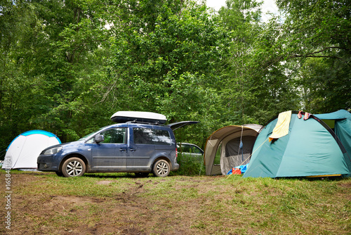Car with roof rack and camping tents