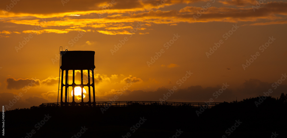 Sunset behind a water tower in the commune known as Sandy Lane, Swansea, Gower, South Wales.